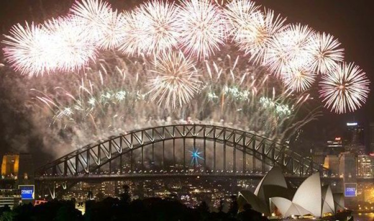 Fireworks explode over Sydney Harbour at midnight, ushering in the new year, in Sydney