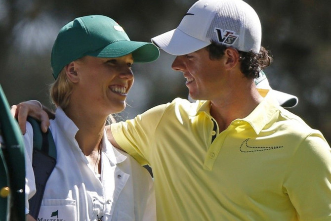 File photo of McIlroy of Northern Ireland and his girlfriend, tennis player Wozniacki of Denmark, during the annual Masters Par 3 Contest in Augusta (Reuters)