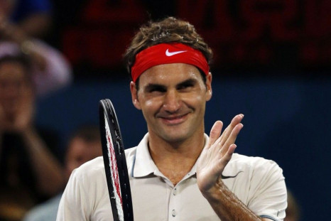 Roger Federer of Switzerland celebrates after winning his men's singles match against Jarkko Nieminen of Finland at the Brisbane International tennis tournament in Brisbane