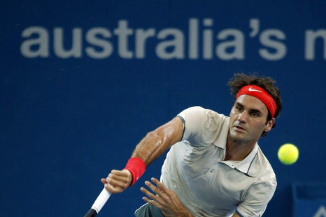 Roger Federer of Switzerland serves to Lleyton Hewitt of Australia during their men&#039;s final match at the Brisbane International tennis tournament