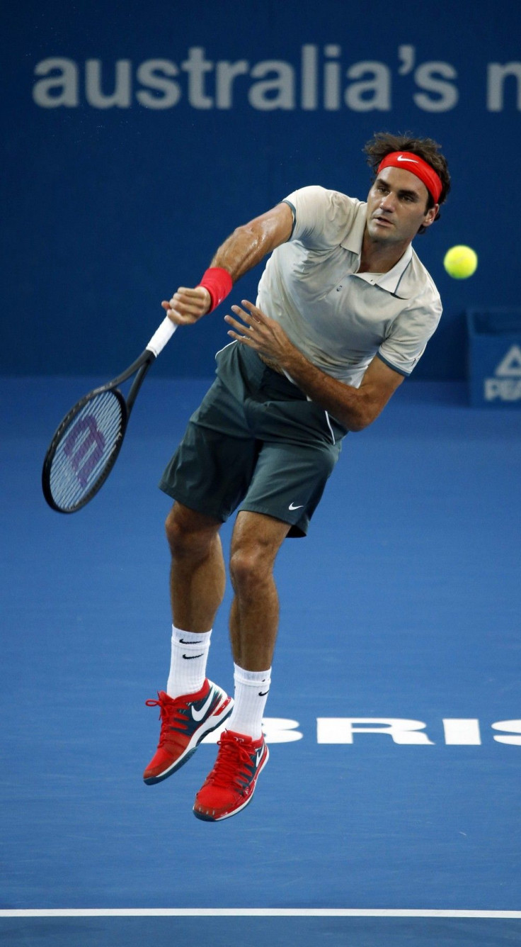 Roger Federer of Switzerland serves to Lleyton Hewitt of Australia during their men's final match at the Brisbane International tennis tournament