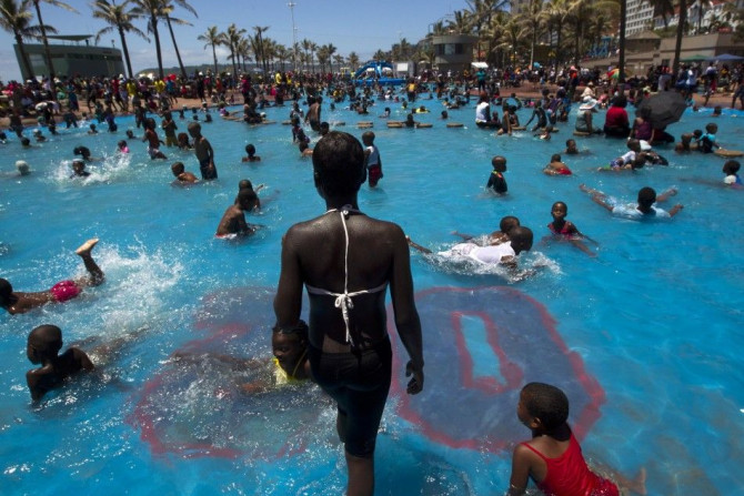 People swim in public pools as thousands took to the beaches on New Year&#039;s Day in Durban January 1, 2014.