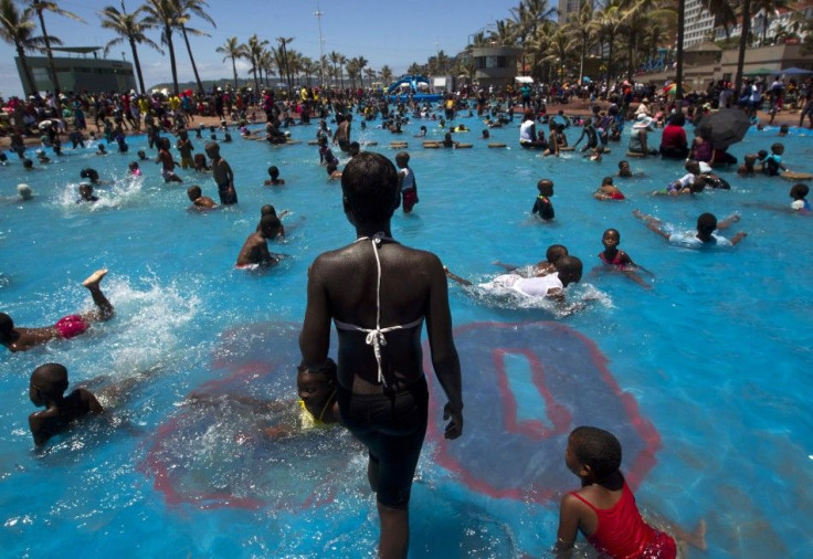 People swim in public pools as thousands took to the beaches on New Year&#039;s Day in Durban January 1, 2014.