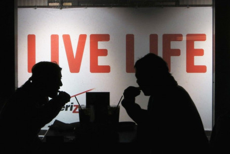 People dine in front of a Live Life sign at a restaurant in Times Square in New York, January 2, 2014. Picture taken January 2, 2014.