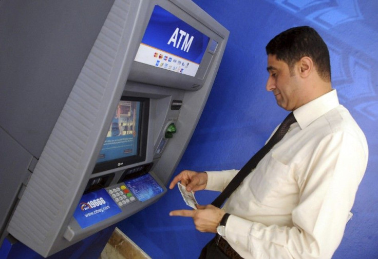 A man withdraws money from an ATM machine 