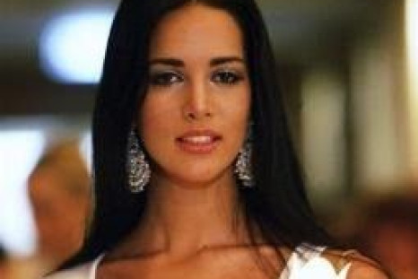 Miss Universe 2005 contestant Monica Spear of Venezuela takes part in an AIDS candlelight memorial in a Bangkok hotel to remember those who have lost their lives to the disease in this May 16, 2005 file photo.  REUTERS/Chaiwat Subprasom/Files