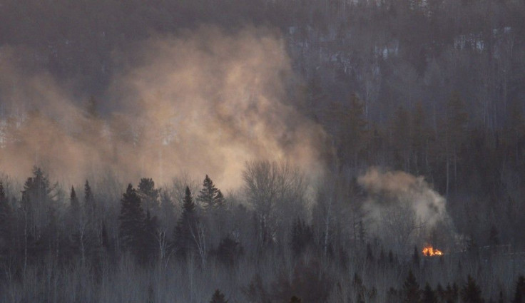 Flames and Smoke are Seen at the Site of a Train Derailment in Wapske