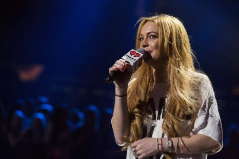 Actress Lindsay Lohan introduces singer Miley Cyrus during the 2013 Z100 Jingle Ball in New York