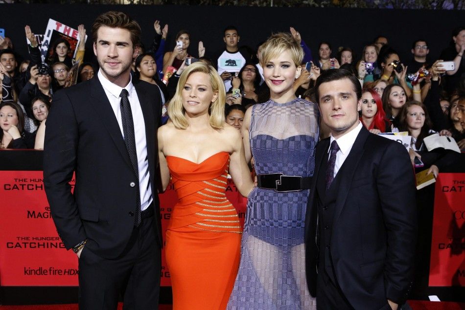 Cast members Liam Hemsworth, Elizabeth Banks, Jennifer Lawrence and Josh Hutcherson pose at the premiere of quotThe Hunger Games Catching Firequot in Los Angeles