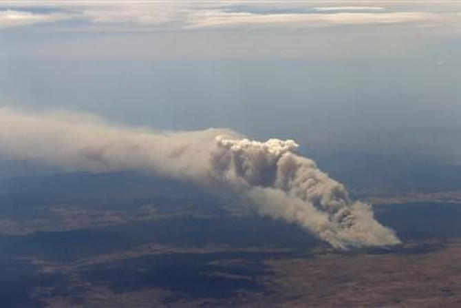 Smoke rises from the Yarrabin bushfire, burning out of control near Cooma, about 100km (62 miles) south of Canberra January 8, 2013.