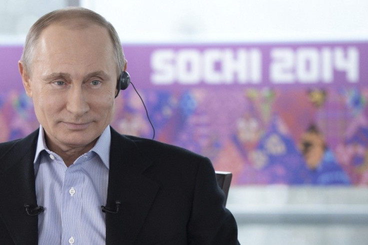 Russian President Vladimir Putin listens to a journalist's question during a televised news conference in Sochi January 19, 2014.  REUTERS/Alexei Nikolsky/RIA Novosti/Kremlin