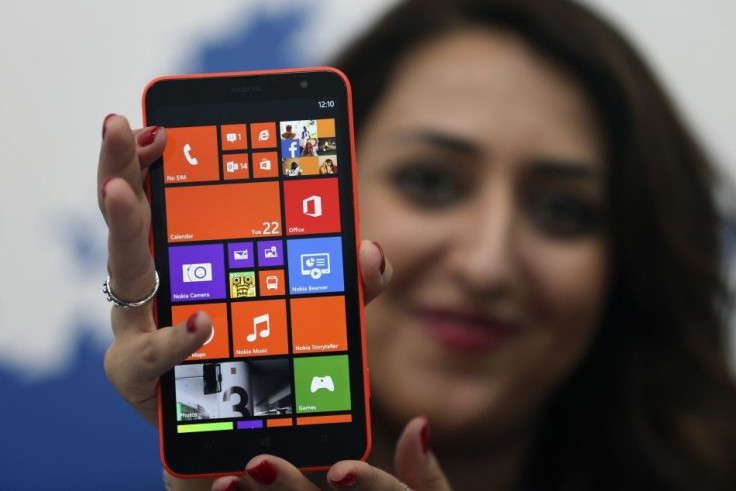 A model displays the Lumia 1320 smartphone during its launch in Abu Dhabi 
