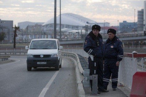 Russian traffic police officers stand guard during patrol on a road near venues at the Olympic Park near Sochi January 7, 2014. Russian forces went on combat alert in Sochi and tightened restrictions on access to the Black Sea resort on Tuesday as part of