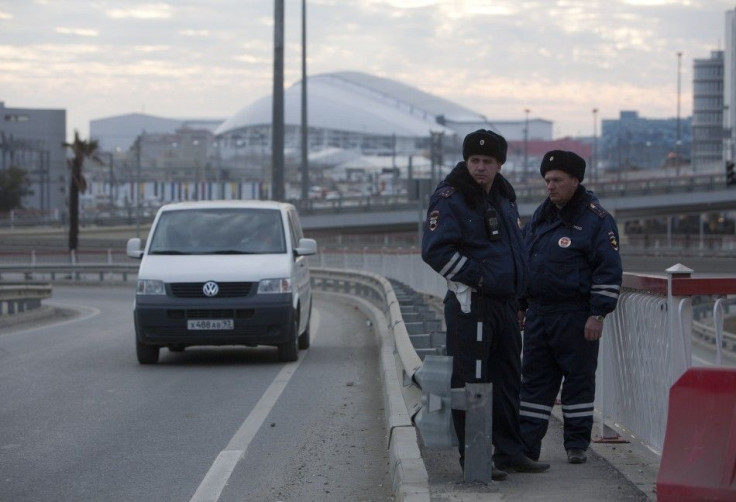 Russian traffic police officers stand guard during patrol on a road near venues at the Olympic Park near Sochi January 7, 2014. Russian forces went on combat alert in Sochi and tightened restrictions on access to the Black Sea resort on Tuesday as part of