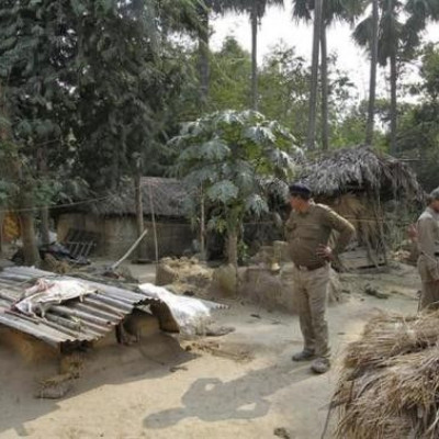 Police personnel inspect the area where a woman was gang-raped at Birbhum district in West Bengal January 23, 2014.