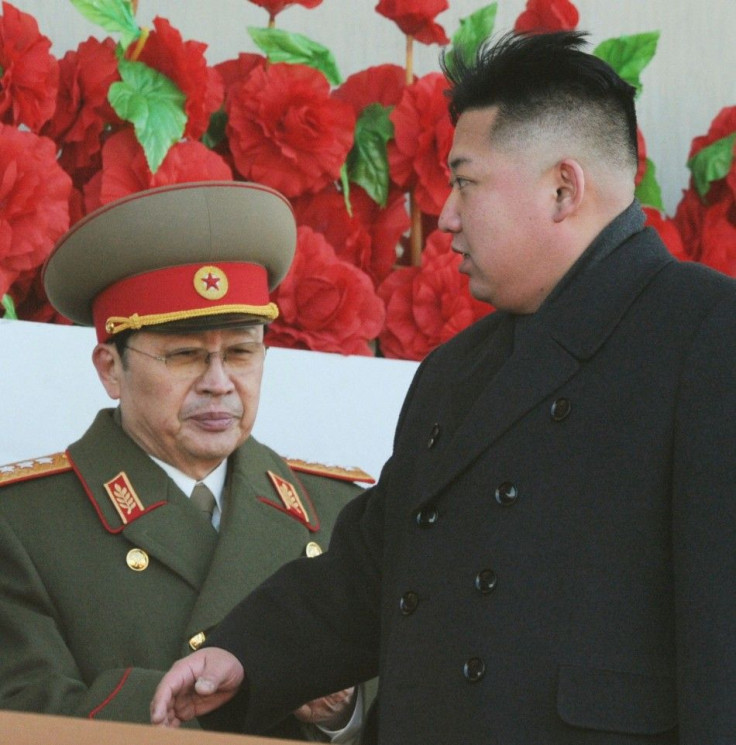 North Korean leader Kim Jong-un (R), flanked by his uncle North Korean politician Jang Song Thaek