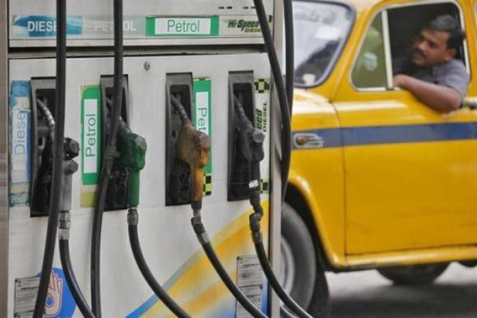 A driver waits in a taxi for his turn to fill up his tank with diesel at a fuel station in Kolkata June 14, 2012.