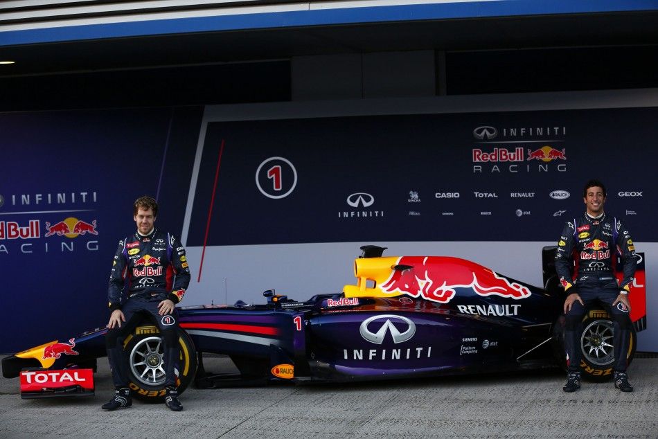 Red Bull Formula One drivers Vettel of Germany and Ricciardo of Australia pose with the new RB10 at the Jerez racetrack in southern Spain