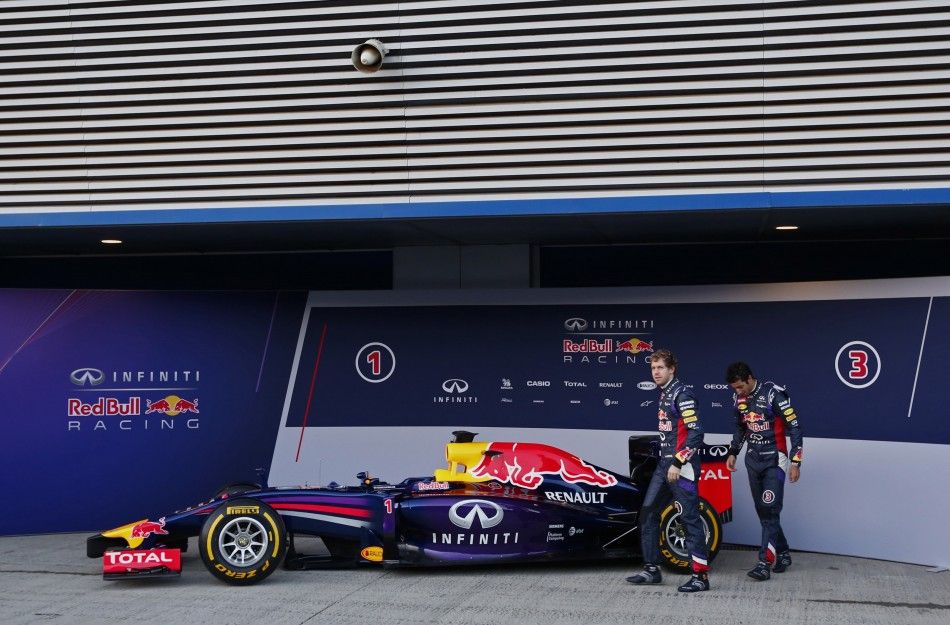 Red Bull Formula One drivers Vettel of Germany and Ricciardo of Australia walks after unveiling the new RB10 at the Jerez racetrack in southern Spain