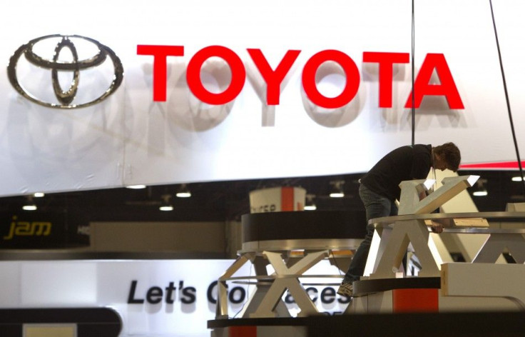 A worker sets up a display near the Toyota booth in preparation for the 2014 Consumer Electronics Show (CES) at the Las Vegas Convention Center in Las Vegas, Nevada, January 4, 2014. REUTERS/Steve Marcus