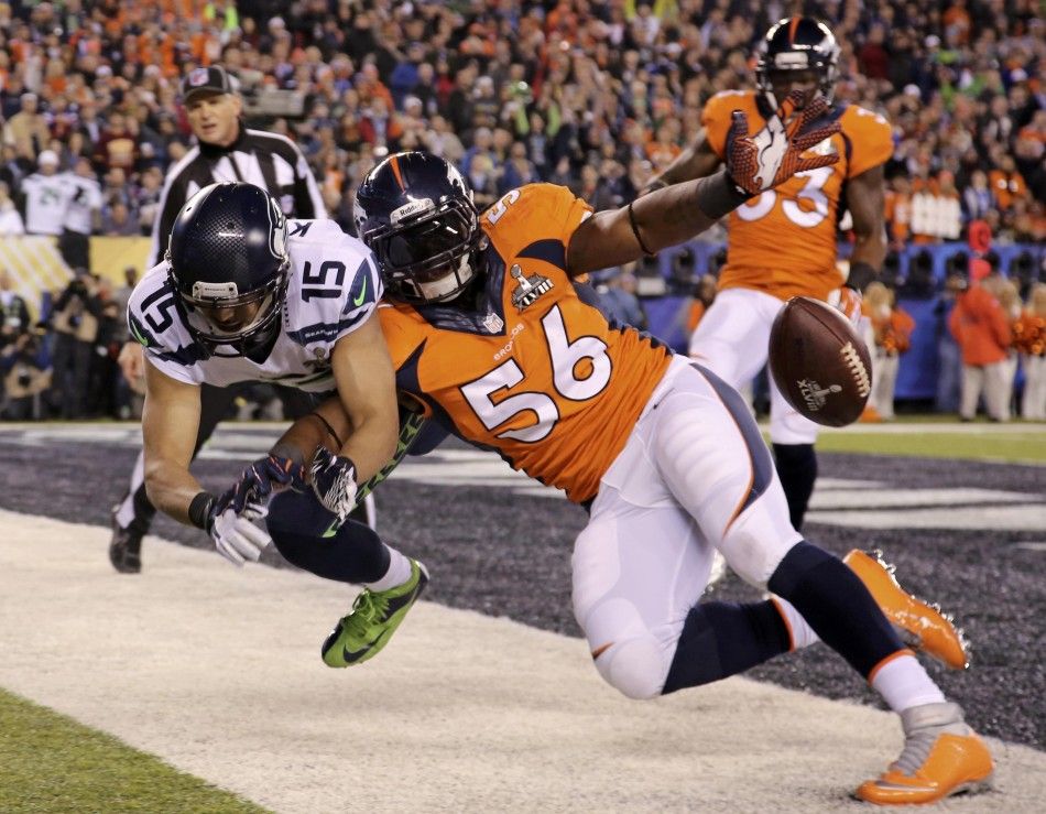 Seahawks Harvin runs with ball past Broncos Ihenacho during their NFL Super Bowl XLVIII football game in East Rutherford