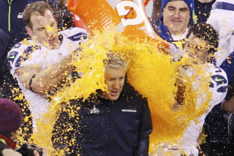 Seahawks head coach Carroll gets gatorade dumped on him in celebration by Wilson near the end of the fourth quarter against the Broncos during the NFL Super Bowl XLVIII football game in East Rutherford