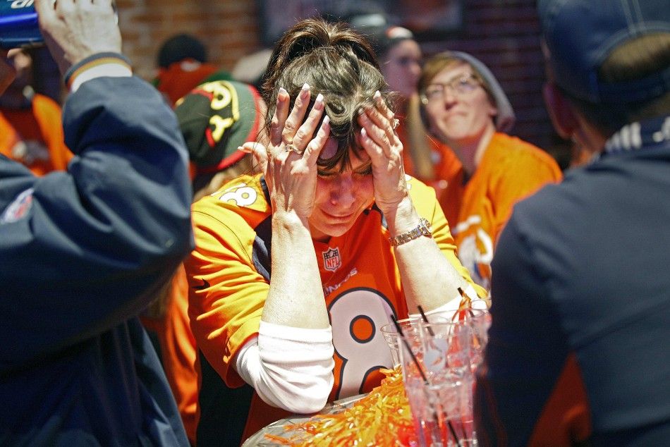 A Broncos fan reacts to a Seahawks touchdown while watching the NFL Super Bowl XLVIII in Denver
