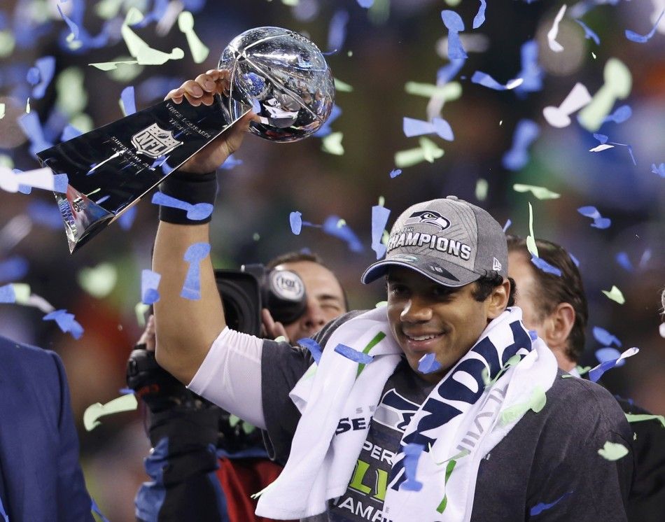 Seattle Seahawks quarterback Russell Wilson holds up the Vince Lombardi Trophy after winning the NFL Super Bowl XLVIII football game in East Rutherford, New Jersey