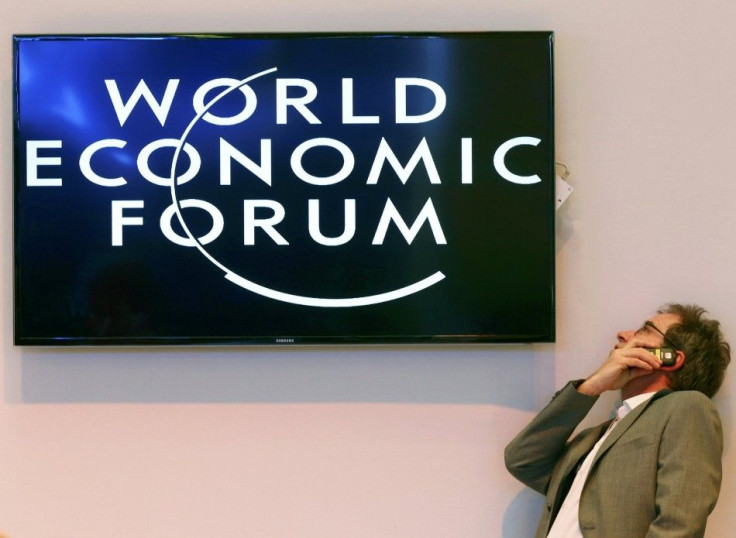 A participant speaks on his mobile phone between sessions during the annual meeting of the World Economic Forum (WEF) in Davos January 22, 2014.      REUTERS/Ruben Sprich