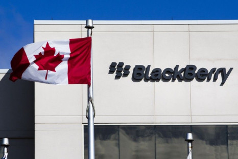 File photo of A Canadian flag waves in front of a Blackberry logo at the Blackberry campus in Waterloo, September 23, 2013.    REUTERS/Mark Blinch