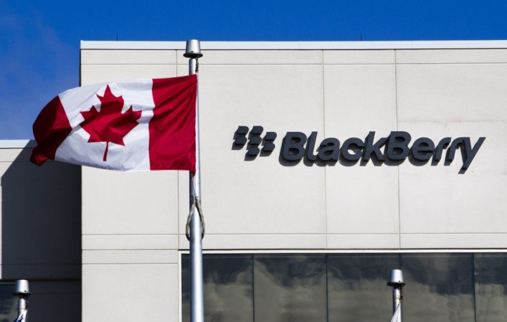 File photo of A Canadian flag waves in front of a Blackberry logo at the Blackberry campus in Waterloo, September 23, 2013.    REUTERS/Mark Blinch