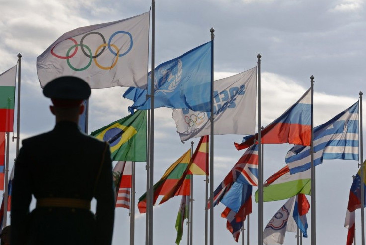 A Russian soldier stands in front of the flags during the welcoming ceremony for the U.S Olympic team in the Athletes Village at the Olympic Park ahead of the 2014 Winter Olympic Games in Sochi February 6, 2014.  REUTERS/Laszlo Balogh