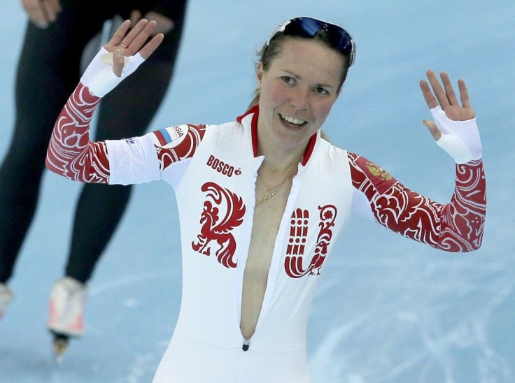 Olga Graf of Russia waves after her women&#039;s 3000 meters speed skating race during the 2014 Sochi Winter Olympics