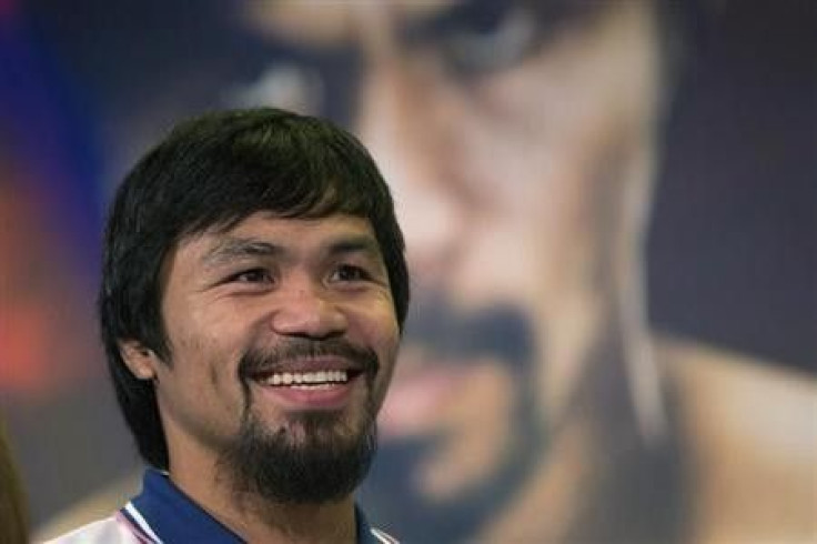 Boxer Manny Pacquiao of the Philippines smiles during a news conference in New York August 6, 2013. Pacquiao will fight Brandon Rios of the U.S. in a welterweight match at the Venetian Macao in Macau on November 24. REUTERS/SHANNON STAPLETON