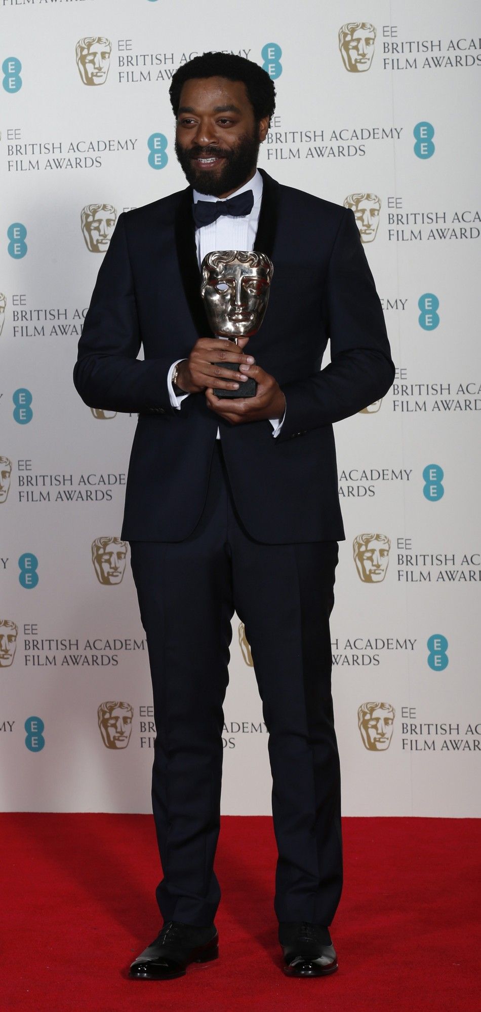 Chiwetel Ejiofor celebrates after winning Best Actor for quot12 Years a Slavequot at the BAFTA awards ceremony in London