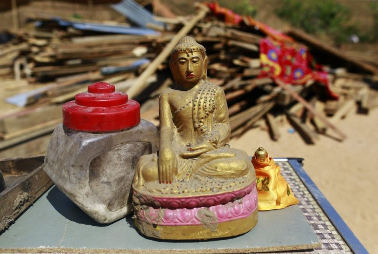 A Buddha statue is recovered after homes of Thameehla village illegally constructed on land owned by the military, were demolished by the Yangon division government, at Hlegue township