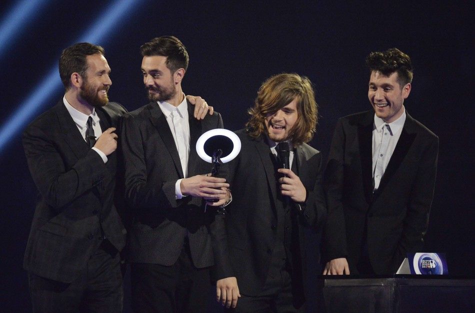 Members of Bastille react after being presented with the British Breakthrough Act award at the BRIT Awards in London