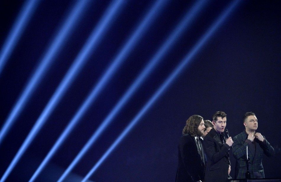 The Arctic Monkeys react after being presented with the British Album award at the BRIT Awards in London