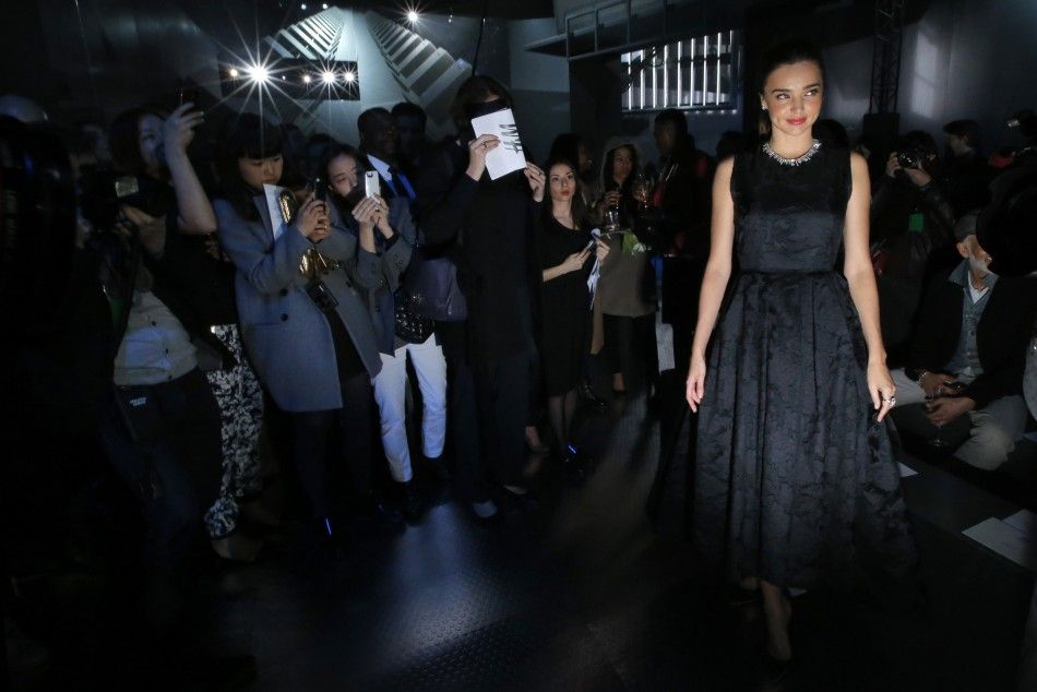 Australian model Miranda Kerr poses for photographers before HMs FallWinter 2014-2015 womens ready-to-wear collection during Paris Fashion Week