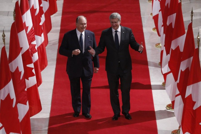 Canada's PM Harper walks with the Aga Khan in the Hall of Honour on Parliament Hill in Ottawa
