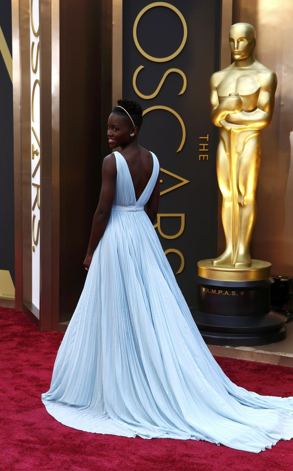 Lupita Nyongo, best supporting actress nominee for her role in quot12 Years a Slavequot and wearing a Prada gown, arrives at the 86th Academy Awards in Hollywood