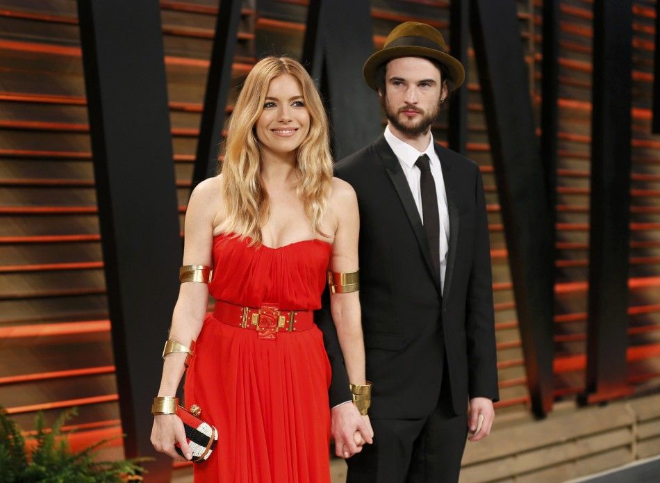 Actor Tom Sturridge and his partner Sienna Miller arrive at the 2014 Vanity Fair Oscars Party in West Hollywood