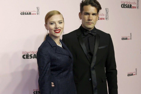 US actress Scarlett Johansson and her partner Romain Dauriac pose as they arrive for the 39th Cesar Awards ceremony in Paris
