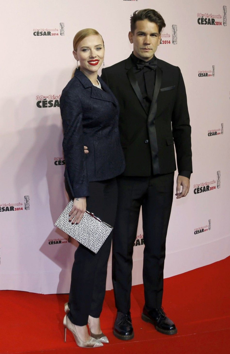 US actress Scarlett Johansson and her partner Romain Dauriac pose as they arrive for the 39th Cesar Awards ceremony in Paris