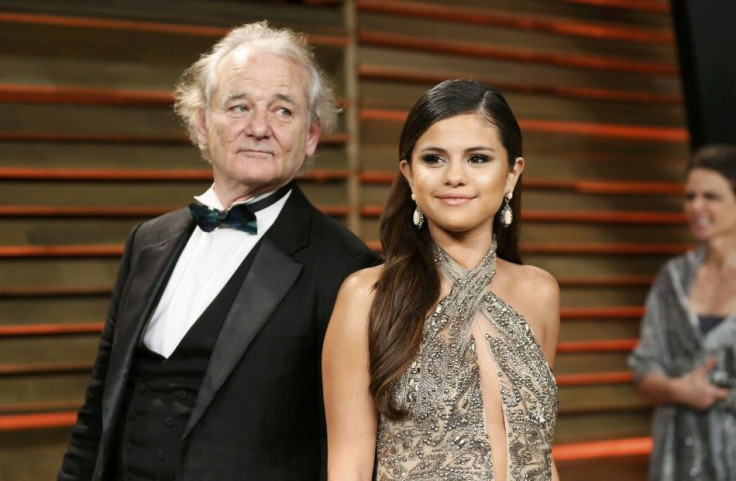 Actor Bill Murray &quot;photobombs&quot; singer Selena Gomez as they arrive for the 2014 Vanity Fair Oscars Party in West Hollywood