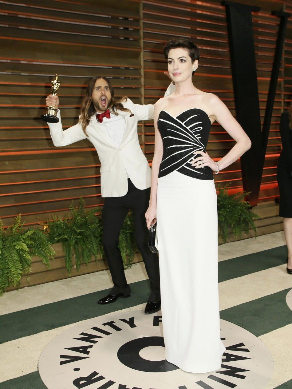 Leto jokes around as actress Anne Hathaway poses as they arrive at the 2014 Vanity Fair Oscars Party in West Hollywood