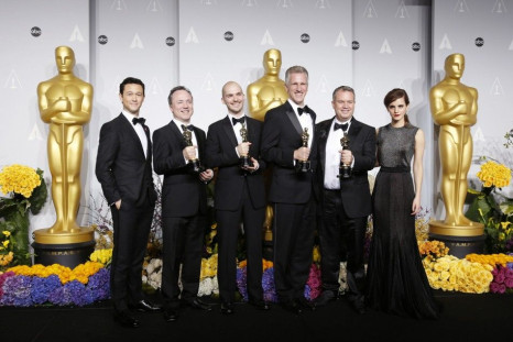 Tim Webber, Chris Lawrence, David Shirk and Neil Corbould pose with their award for best visual effects for their film &quot;Gravity&quot; with presenters Joseph Gordon-Levitt and Emma Watson