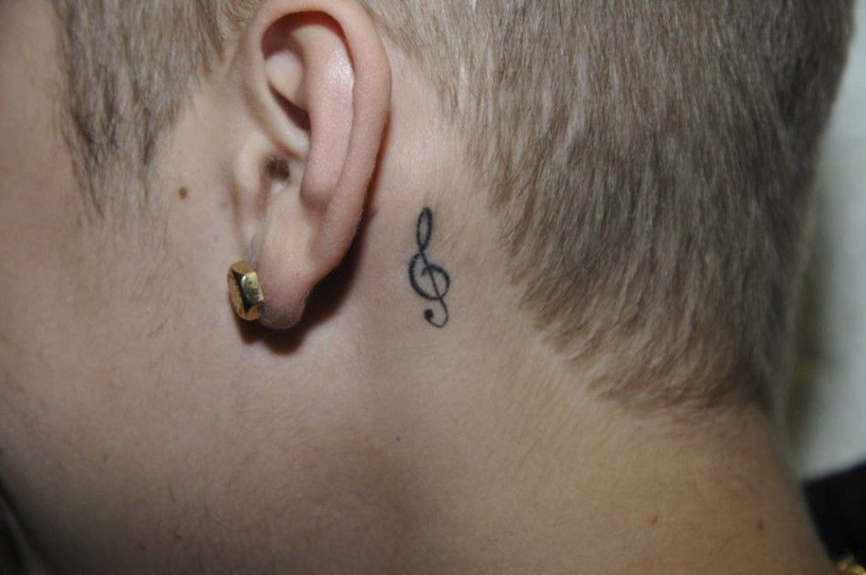 A tattoo is seen behind the left ear of Canadian pop singer Justin Bieber, while in police custody in Miami Beach, Florida January 23, 2014 in this Miami Beach Police Department handout released to Reuters on March 4, 2014. Bieber was charged with driving