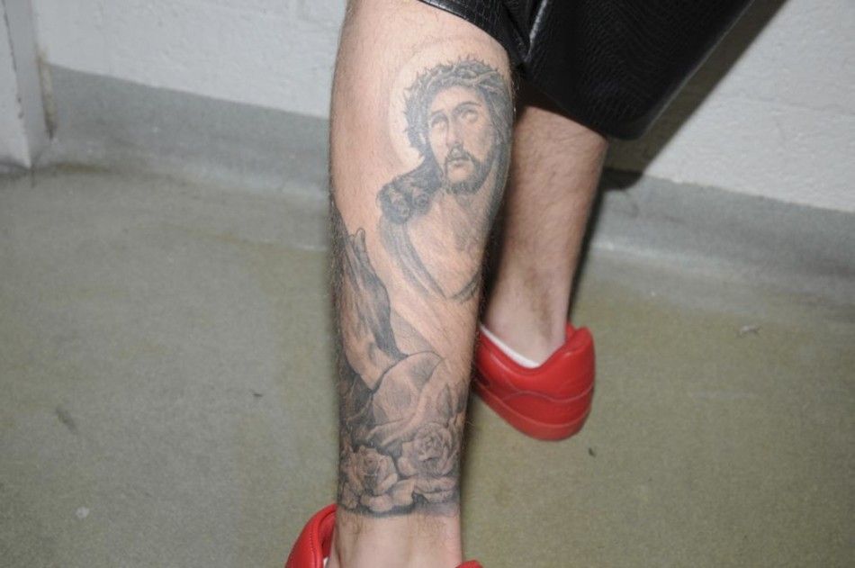 A tattoo of Jesus Christ is seen on the left leg of Canadian pop singer Justin Bieber, while in police custody in Miami Beach, Florida January 23, 2014 in this Miami Beach Police Department handout released to Reuters on March 4, 2014. Bieber was charged 