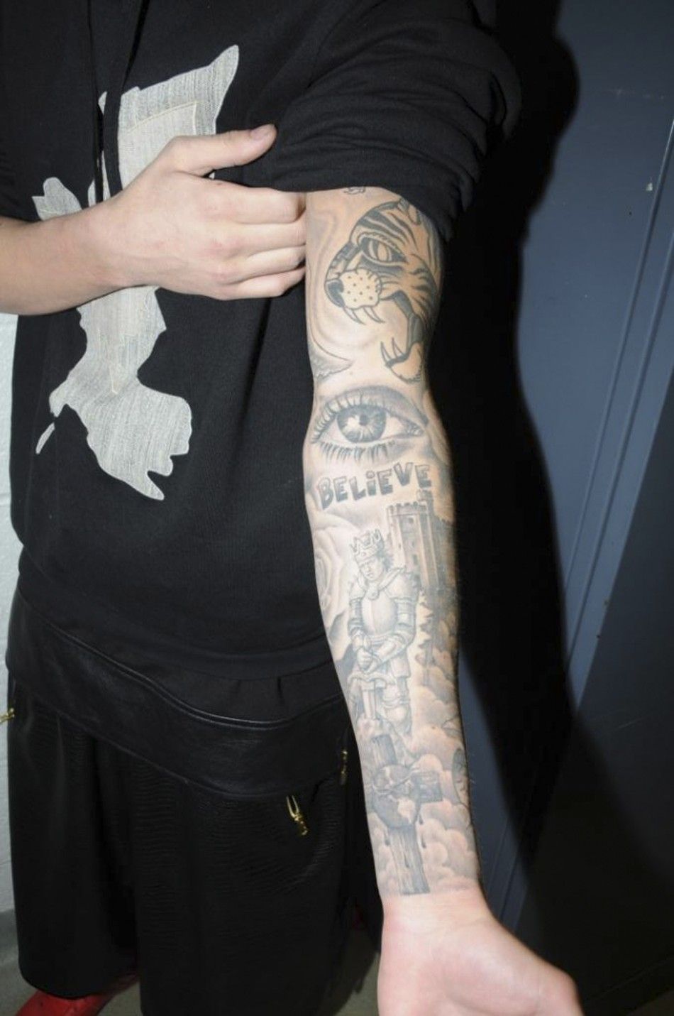 A tattoo is seen on the left arm of Canadian pop singer Justin Bieber, while in police custody in Miami Beach, Florida January 23, 2014 in this Miami Beach Police Department handout released to Reuters on March 4, 2014. Bieber was charged with driving und